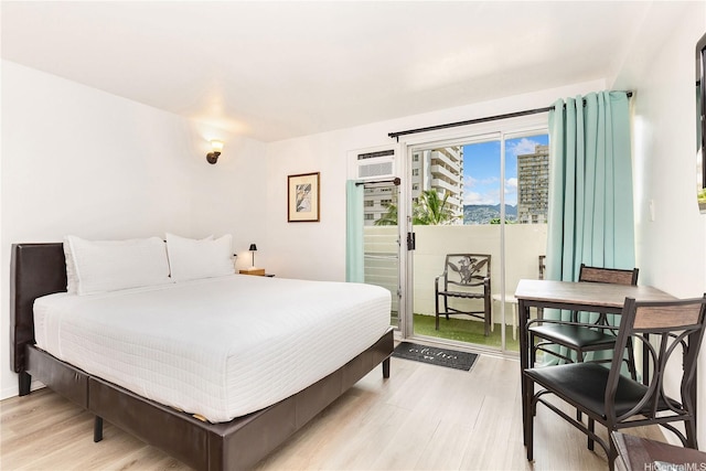 2450 Prince Edward St Unit 506A, Honolulu, HI 96815 - bedroom featuring access to exterior, light wood finished floors, and an AC wall unit