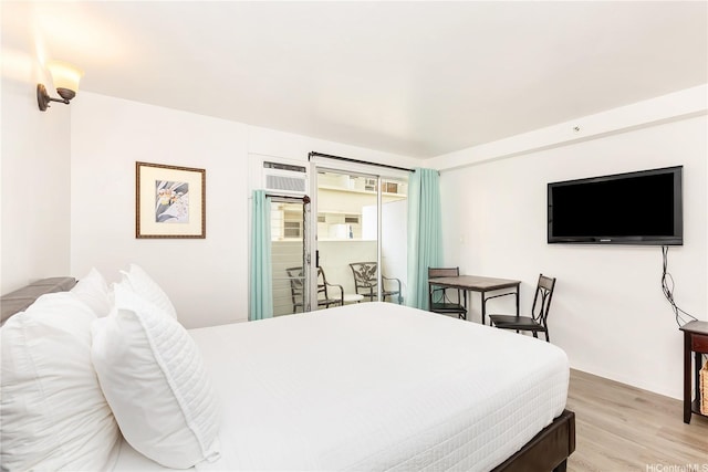 2450 Prince Edward St Unit 506A, Honolulu, HI 96815 - bedroom with light wood finished floors, access to exterior, and a wall mounted air conditioner