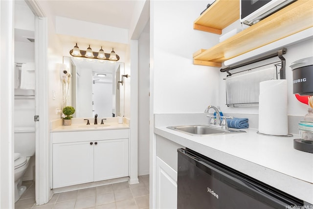 2450 Prince Edward St Unit 506A, Honolulu, HI 96815 - kitchen with dishwashing machine, light countertops, light tile patterned floors, and white cabinets