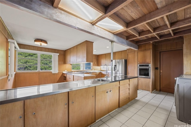 2316 Round Top Dr, Honolulu, HI 96822 - kitchen featuring stainless steel appliances, a wooden ceiling with exposed beams, stainless steel countertops, wood walls, and washer / dryer