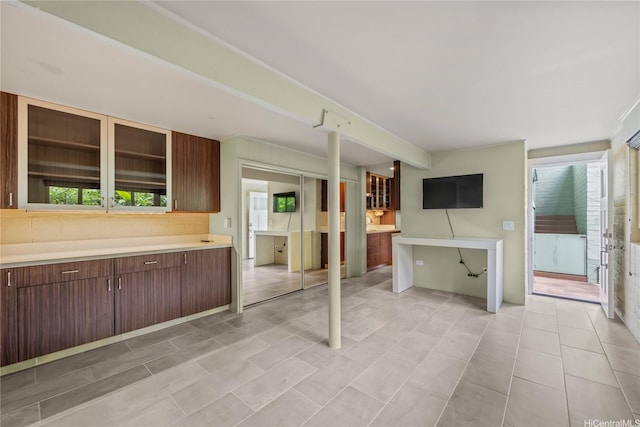 2316 Round Top Dr, Honolulu, HI 96822 - kitchen with light countertops, glass insert cabinets, and dark brown cabinets