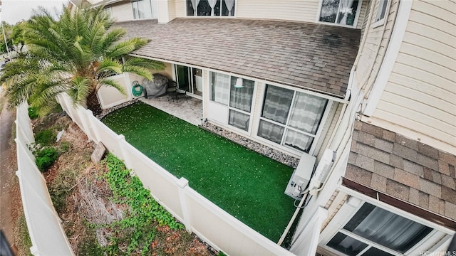 91-950 Laaulu St Unit 42E, Ewa Beach, HI 96706 - exterior space with a fenced backyard and roof with shingles