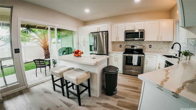 91-950 Laaulu St Unit 42E, Ewa Beach, HI 96706 - kitchen featuring stainless steel appliances, light wood-type flooring, decorative backsplash, a kitchen island, and recessed lighting