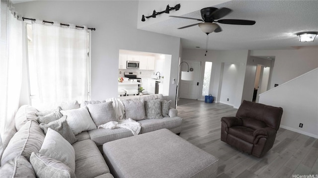 91-950 Laaulu St Unit 42E, Ewa Beach, HI 96706 - living room featuring a ceiling fan, wood finished floors, and a textured ceiling
