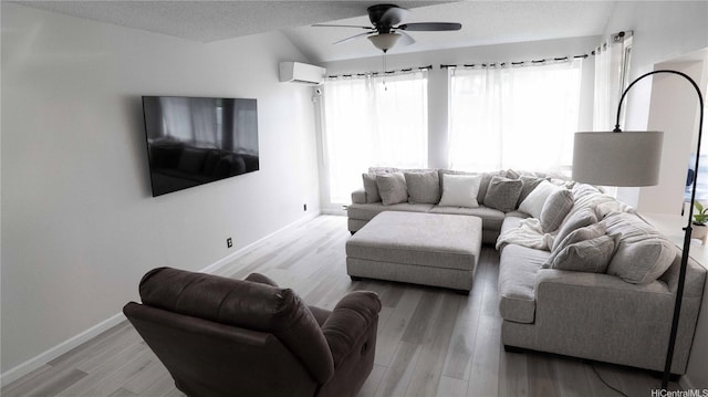 91-950 Laaulu St Unit 42E, Ewa Beach, HI 96706 - living area with ceiling fan, wood finished floors, a textured ceiling, a wall mounted air conditioner, and vaulted ceiling