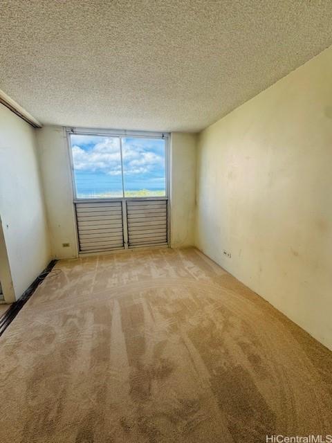 1676 Ala Moana Blvd Unit 1007, Honolulu, HI 96815 - spare room with light carpet and a textured ceiling