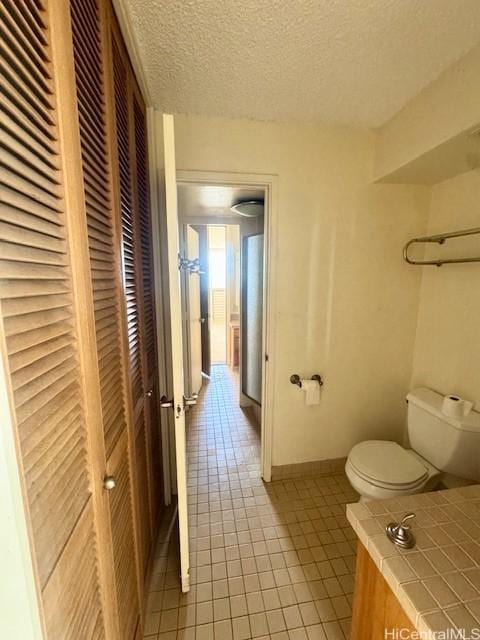 1676 Ala Moana Blvd Unit 1007, Honolulu, HI 96815 - bathroom with tile patterned floors, a closet, and a textured ceiling