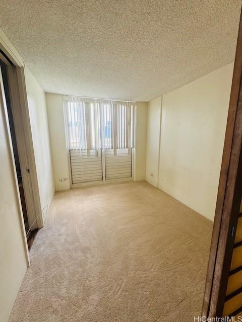 1676 Ala Moana Blvd Unit 1007, Honolulu, HI 96815 - carpeted spare room featuring a textured ceiling