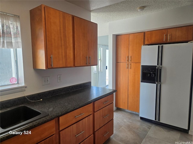 94-1060 Lelehu St, Waipahu, HI 96797 - kitchen featuring white refrigerator with ice dispenser, brown cabinets, and light tile patterned floors