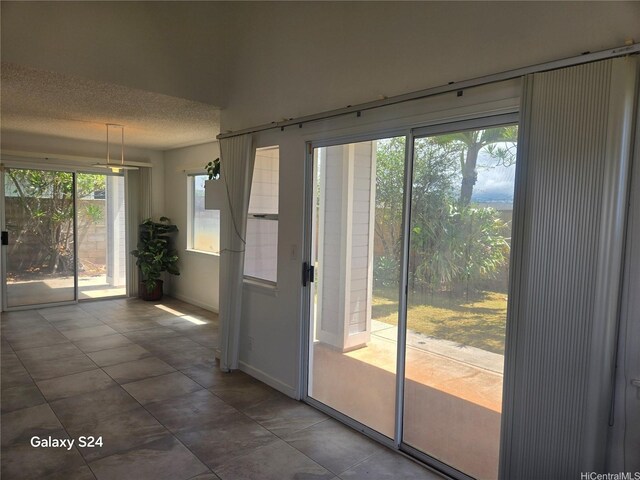 94-1060 Lelehu St, Waipahu, HI 96797 - doorway to outside featuring plenty of natural light, a textured ceiling, and tile patterned flooring