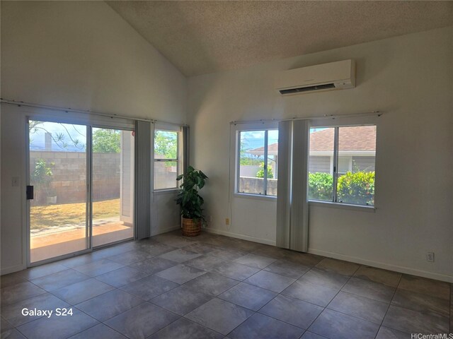 94-1060 Lelehu St, Waipahu, HI 96797 - spare room with a wall mounted AC, lofted ceiling, a textured ceiling, and tile patterned floors