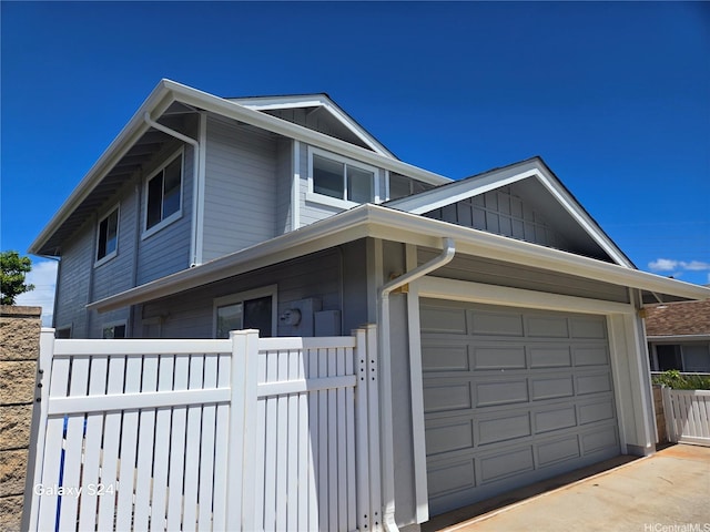 94-1060 Lelehu St, Waipahu, HI 96797 - view of front of home featuring a garage, driveway, and board and batten siding