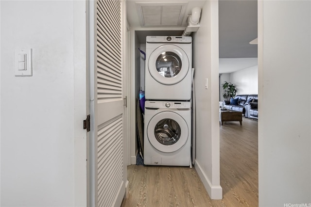 1860 Ala Moana Blvd Unit 1208, Honolulu, HI 96815 - laundry room with stacked washer and clothes dryer and wood finished floors