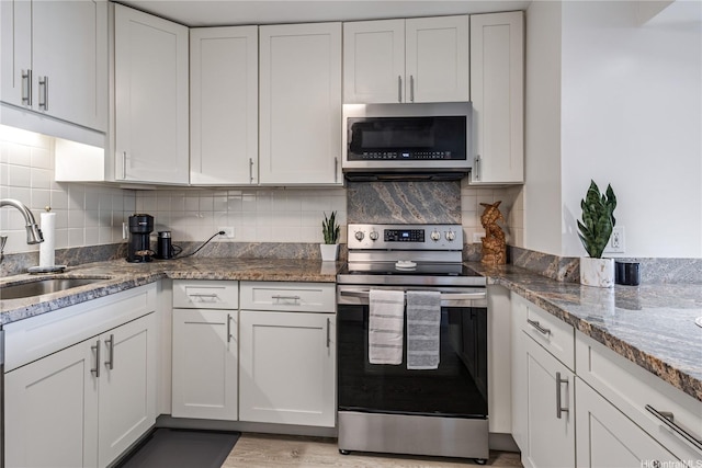 1860 Ala Moana Blvd Unit 1208, Honolulu, HI 96815 - kitchen with appliances with stainless steel finishes, white cabinets, stone counters, and tasteful backsplash