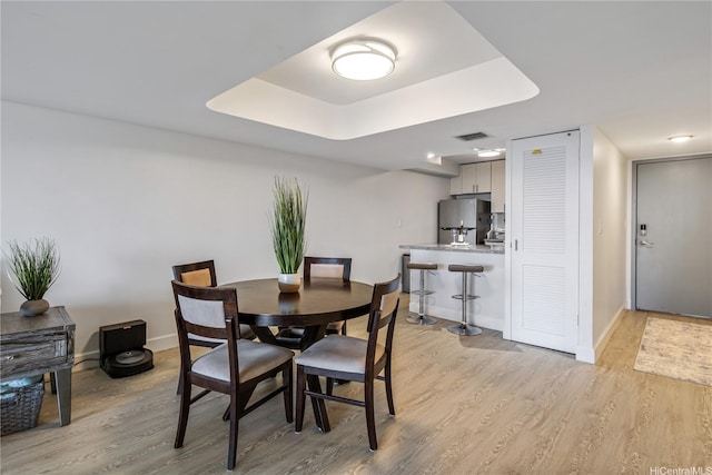1860 Ala Moana Blvd Unit 1208, Honolulu, HI 96815 - dining room with light wood-style flooring and a tray ceiling
