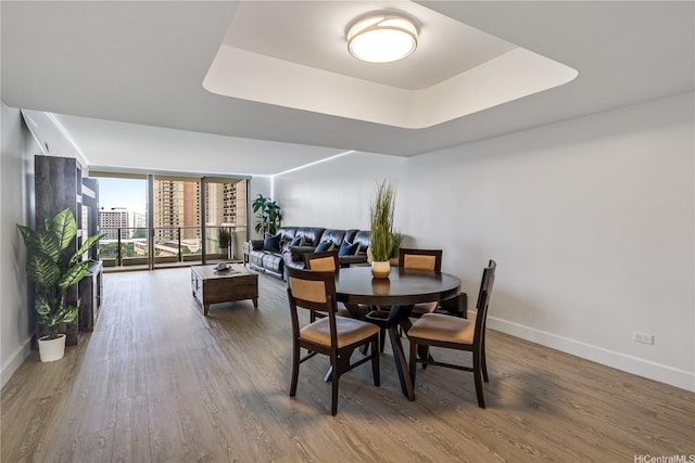 1860 Ala Moana Blvd Unit 1208, Honolulu, HI 96815 - dining space with wood finished floors, a tray ceiling, and expansive windows
