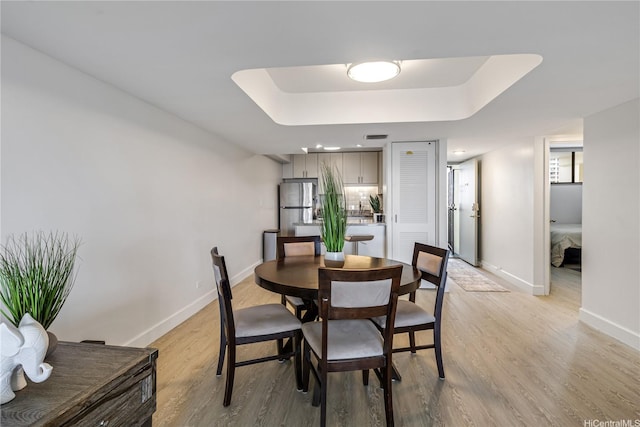 1860 Ala Moana Blvd Unit 1208, Honolulu, HI 96815 - dining room with light wood-type flooring and a raised ceiling