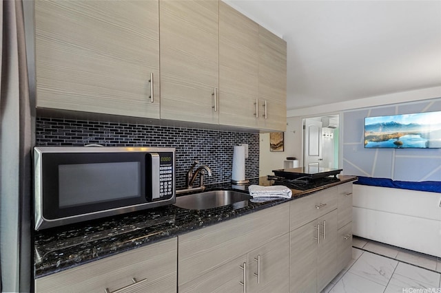 2450 Prince Edward St Unit 1201A, Honolulu, HI 96815 - kitchen with stainless steel microwave, dark stone countertops, light marble finish floors, modern cabinets, and black stovetop