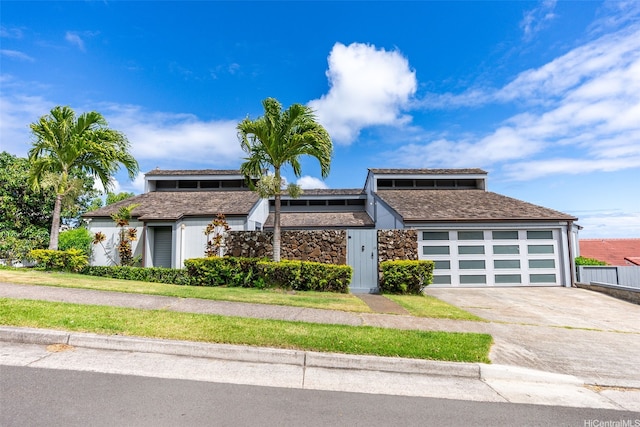 1789 Laukahi St, Honolulu, HI 96821 - mid-century inspired home with driveway, stone siding, and an attached garage