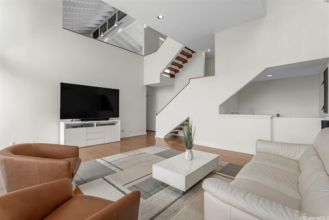 1789 Laukahi St, Honolulu, HI 96821 - living room with stairs, wood finished floors, a high ceiling, and recessed lighting