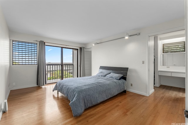 1789 Laukahi St, Honolulu, HI 96821 - bedroom with access to exterior, light wood-style flooring, and track lighting