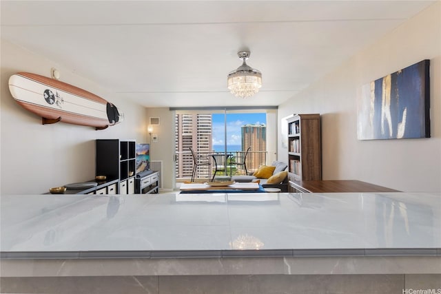400 Hobron Ln Unit 2809, Honolulu, HI 96815 - dining space featuring a chandelier and a wall of windows