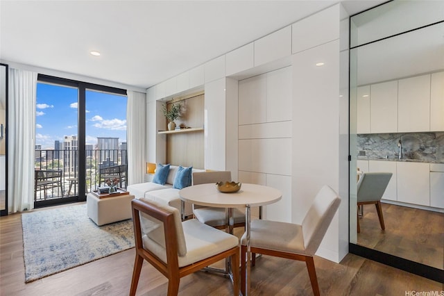 987 Queen St Unit 3209, Honolulu, HI 96814 - dining space with wood finished floors, expansive windows, and a city view