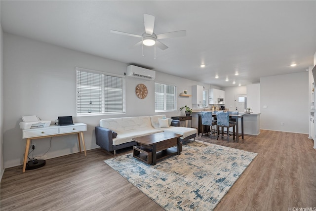 91-1725 Kapeku Loop, Ewa Beach, HI 96706 - living room featuring wood finished floors, a wall unit AC, recessed lighting, and ceiling fan