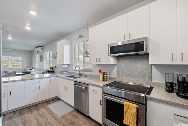 91-1725 Kapeku Loop, Ewa Beach, HI 96706 - kitchen with appliances with stainless steel finishes, light wood-type flooring, white cabinets, backsplash, and recessed lighting