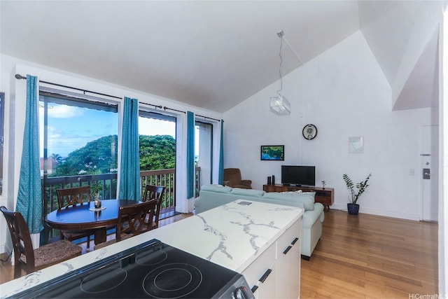 84-718 Ala Mahiku St Unit 21/97C, Waianae, HI 96792 - kitchen featuring stove, light wood-style flooring, white cabinetry, high vaulted ceiling, and open floor plan