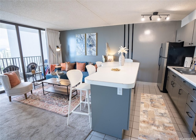 201 Ohua Ave Unit Makai/2808, Honolulu, HI 96815 - kitchen with gray cabinetry, open floor plan, light countertops, light tile patterned floors, and a textured ceiling