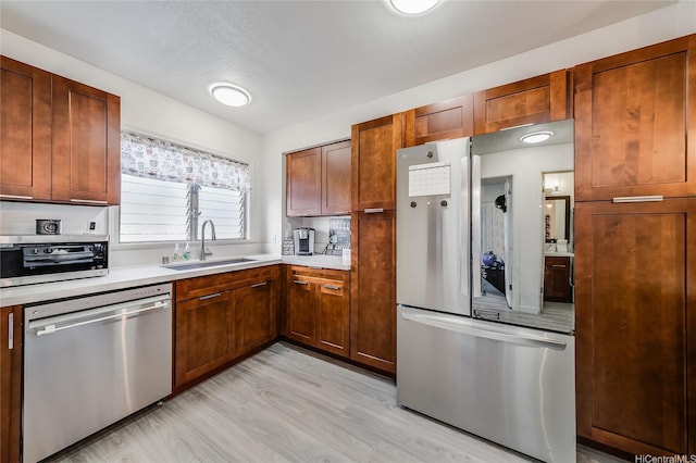 91-630 Kilaha St Unit 1, Ewa Beach, HI 96706 - kitchen with appliances with stainless steel finishes, light countertops, and light wood-type flooring
