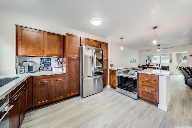91-630 Kilaha St Unit 1, Ewa Beach, HI 96706 - kitchen featuring appliances with stainless steel finishes, a peninsula, open floor plan, light wood-style flooring, and ceiling fan