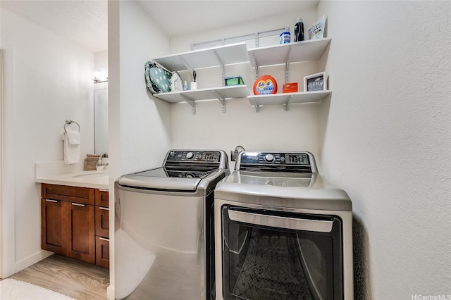 91-630 Kilaha St Unit 1, Ewa Beach, HI 96706 - washroom featuring washing machine and clothes dryer and light wood-type flooring