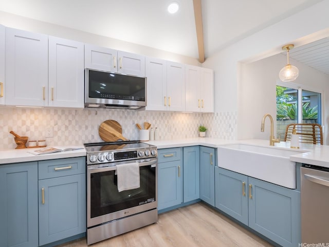 95-161 Kauopae Pl, Mililani, HI 96789 - kitchen featuring appliances with stainless steel finishes, blue cabinets, light countertops, light wood-style flooring, and backsplash