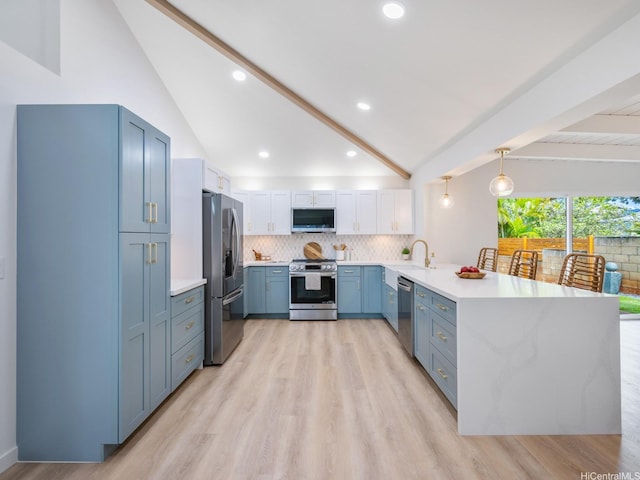 95-161 Kauopae Pl, Mililani, HI 96789 - kitchen featuring appliances with stainless steel finishes, a peninsula, light countertops, blue cabinets, and tasteful backsplash