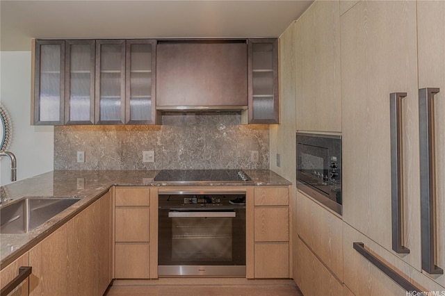 1000 Auahi St Unit 2007, Honolulu, HI 96814 - kitchen featuring black appliances, light stone counters, tasteful backsplash, and glass insert cabinets