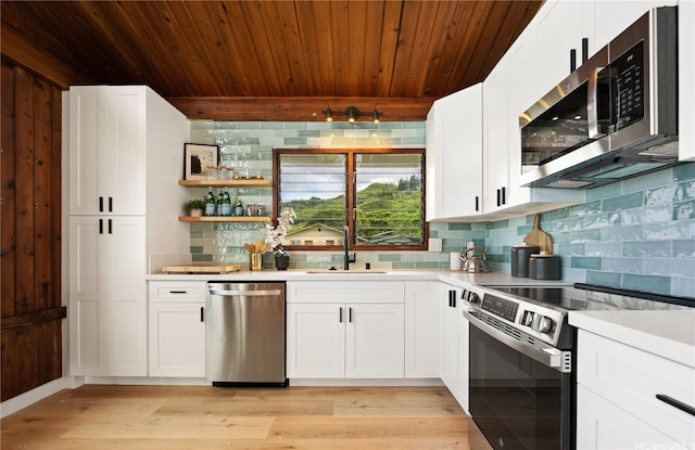 47-070 Laenani Dr Unit C, Kaneohe, HI 96744 - kitchen featuring stainless steel appliances, decorative backsplash, light countertops, light wood-type flooring, and wood ceiling
