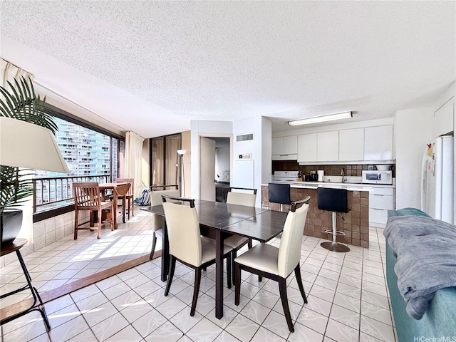 1778 Ala Moana Blvd Unit 2014, Honolulu, HI 96815 - dining space featuring a textured ceiling