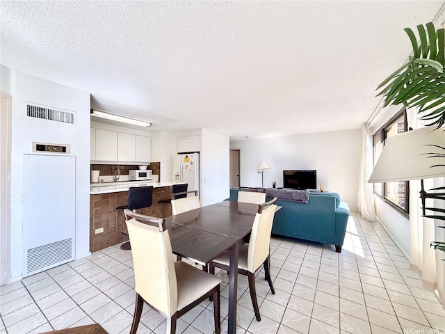 1778 Ala Moana Blvd Unit 2014, Honolulu, HI 96815 - dining room with a textured ceiling and a heating unit