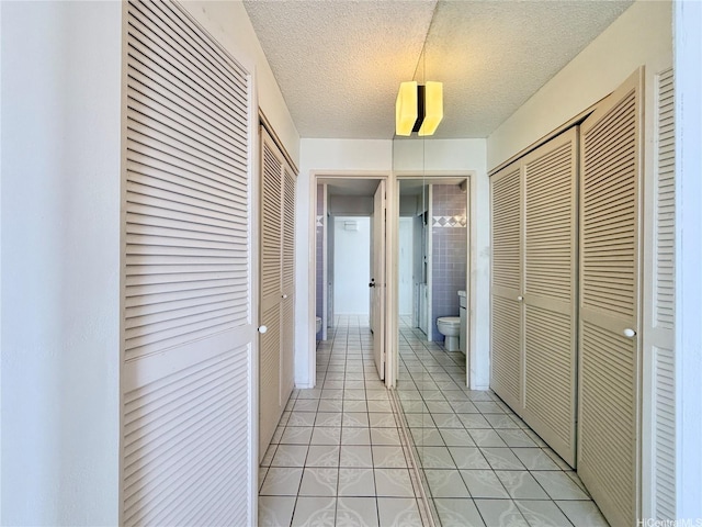 1778 Ala Moana Blvd Unit 2014, Honolulu, HI 96815 - hallway featuring light tile patterned flooring and a textured ceiling