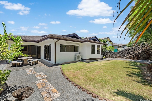 98-653 Papalealii St, Aiea, HI 96701 - rear view of house featuring a yard, a tile roof, stucco siding, and a patio