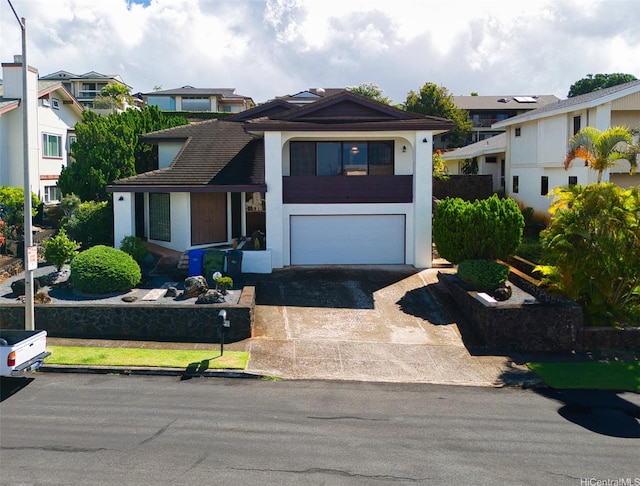 98-653 Papalealii St, Aiea, HI 96701 - view of front of home featuring an attached garage, driveway, stucco siding, and a residential view