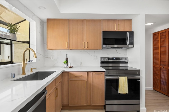 98-653 Papalealii St, Aiea, HI 96701 - kitchen featuring stainless steel appliances, light wood-style flooring, tasteful backsplash, and light stone countertops