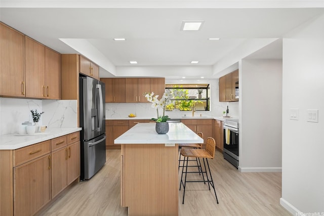 98-653 Papalealii St, Aiea, HI 96701 - kitchen featuring a kitchen breakfast bar, light wood-style flooring, appliances with stainless steel finishes, and a center island