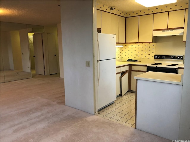 876 Curtis St Unit 1406, Honolulu, HI 96813 - kitchen with white appliances, under cabinet range hood, light carpet, light countertops, and cream cabinets