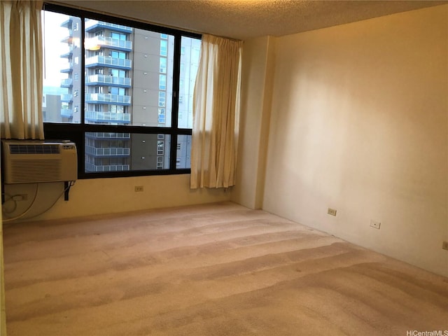 876 Curtis St Unit 1406, Honolulu, HI 96813 - carpeted spare room with plenty of natural light, a textured ceiling, and a wall mounted air conditioner