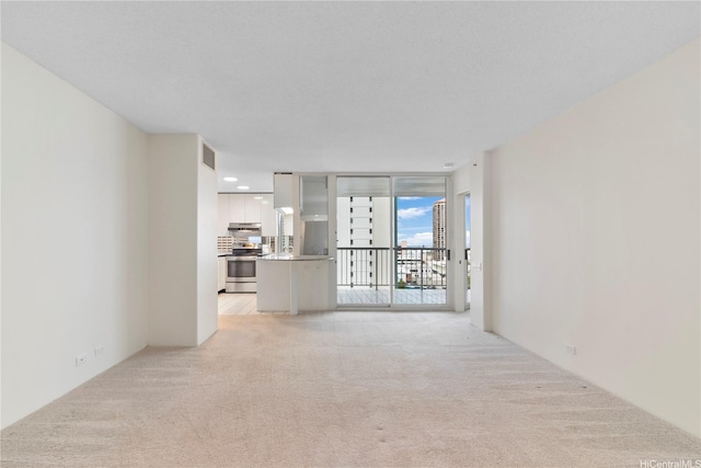 1212 Nuuanu Ave Unit 1104, Honolulu, HI 96817 - unfurnished living room with light colored carpet and a wall of windows