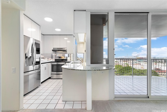 1212 Nuuanu Ave Unit 1104, Honolulu, HI 96817 - kitchen featuring appliances with stainless steel finishes, under cabinet range hood, a peninsula, modern cabinets, and white cabinets