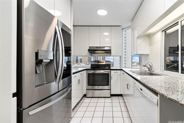 1212 Nuuanu Ave Unit 1104, Honolulu, HI 96817 - kitchen with appliances with stainless steel finishes, extractor fan, light tile patterned floors, and white cabinetry